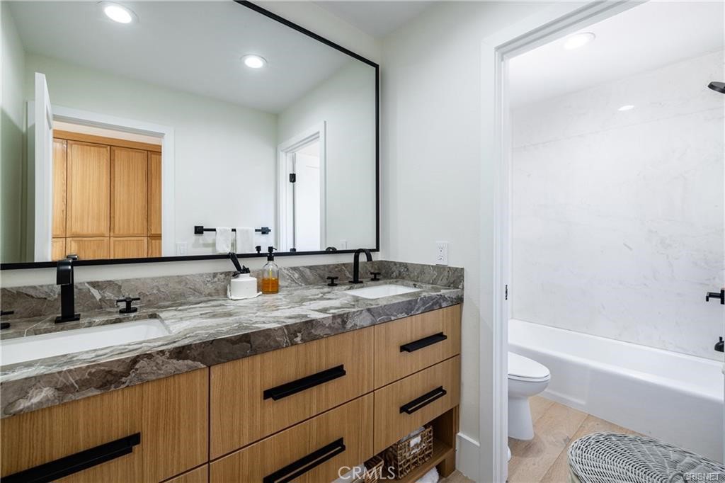 3626 Paseo Primario Calabasas, CA 91302 - Photo 26 of 41 a bathroom with a granite countertop sink a toilet and bathtub
