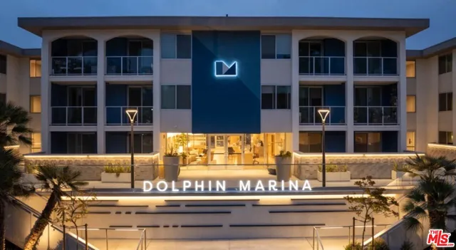 a front view of a building with a garden