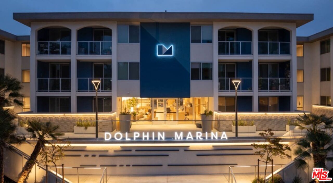 a front view of a building with a garden