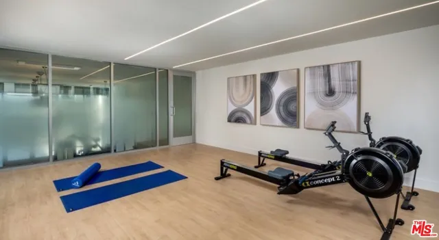 a room with gym equipment and a large window