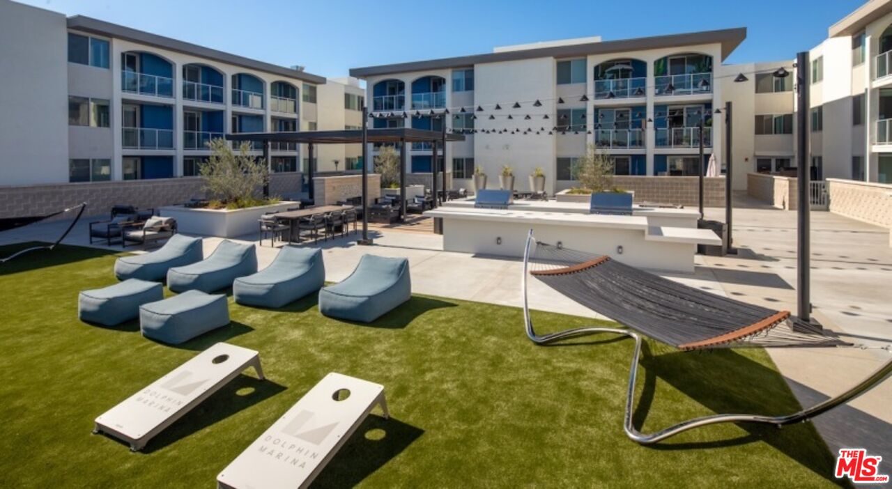 13900 Panay Way, Unit M125 Marina del Rey, CA 90292 - Photo 20 of 23 a living room with lots of furniture and a rug