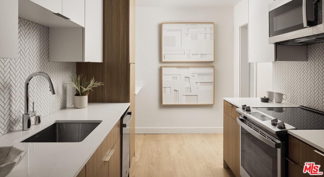 13900 Panay Way, Unit M125 Marina del Rey, CA 90292 - Photo 8 of 23 a kitchen with a sink cabinets and a stove