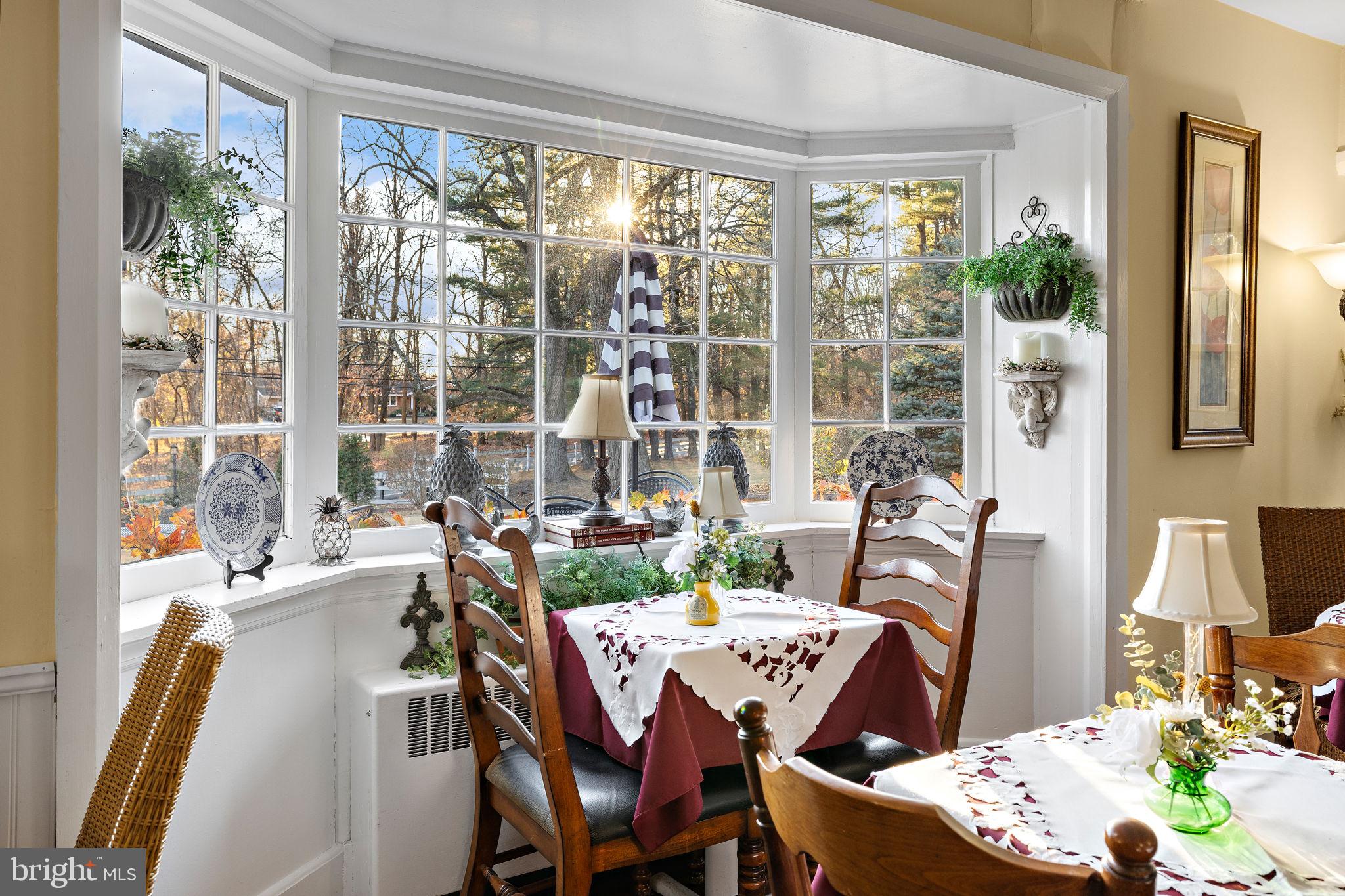 1324 River Road New Hope, PA 18938 - Photo 23 of 70 a view of a dining room with furniture large windows and wooden floor