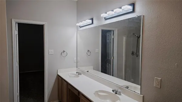 a bathroom with a sink vanity and mirror