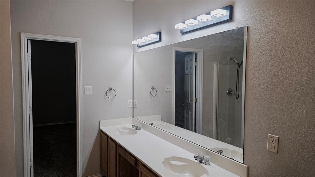 3433 Ingram Road Sachse, TX 75048 - Photo 11 of 23 a bathroom with a sink vanity and mirror