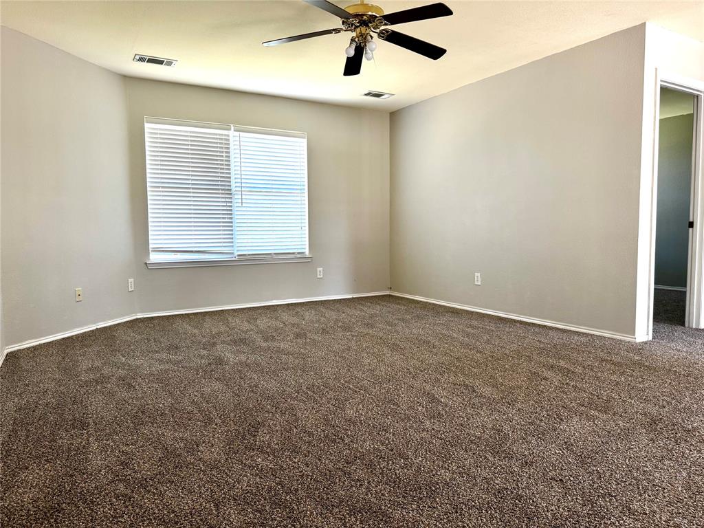 3433 Ingram Road Sachse, TX 75048 - Photo 13 of 23 a view of a livingroom with a ceiling fan and window