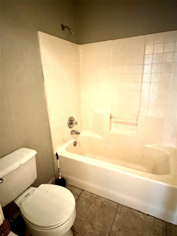3433 Ingram Road Sachse, TX 75048 - Photo 20 of 23 a white toilet sitting next to a bath tub