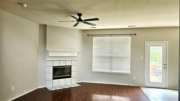 a view of a livingroom with a ceiling fan and window