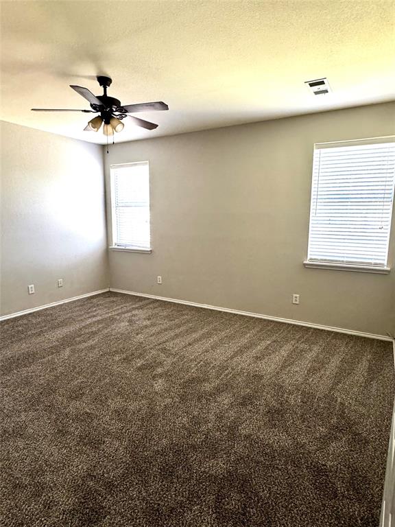 3433 Ingram Road Sachse, TX 75048 - Photo 10 of 23 an empty room with a window and a fan