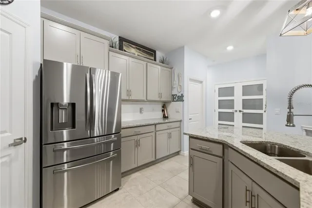 a kitchen with stainless steel appliances a refrigerator sink and cabinets