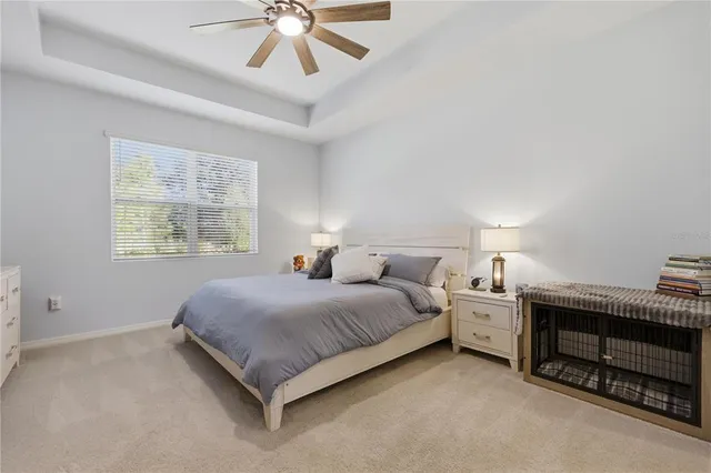 a spacious bedroom with a bed and a chandelier
