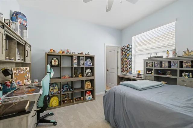 a bedroom with furniture and a book shelf