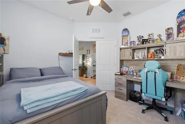 a bed room with a bed and a desk