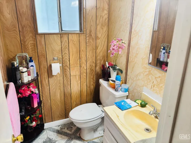 a bathroom with a sink mirror vanity and toilet