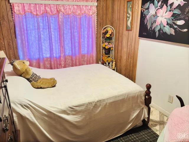 a bed sitting in a bedroom next to a window