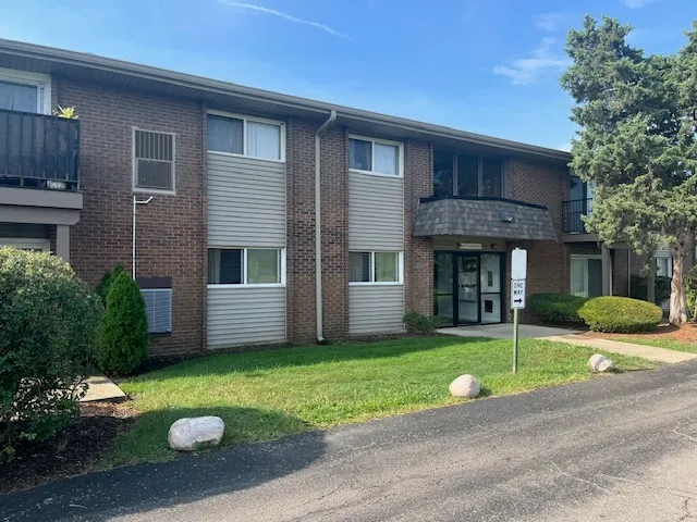 a view of a house with a yard and a garden