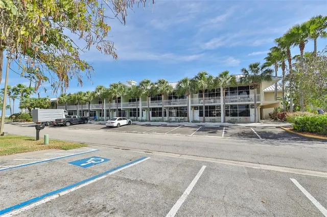 a view of a swimming pool with a lawn chairs and a fire pit
