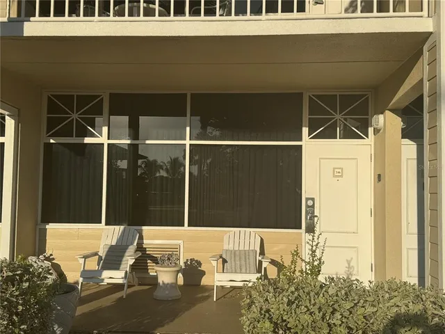 a view of a patio with table and chairs and potted plants