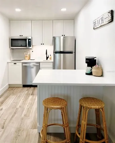 a view of kitchen with furniture and wooden floor