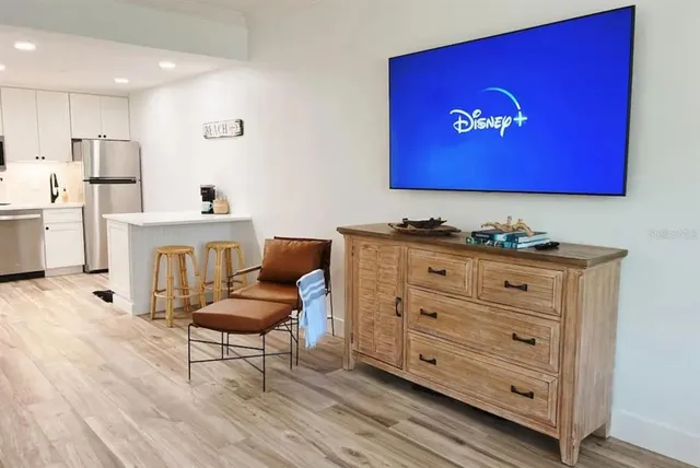 a spacious bedroom with a bed and wooden floor
