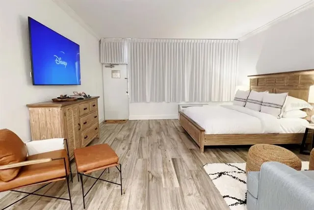 a bedroom with a bed and a night stand