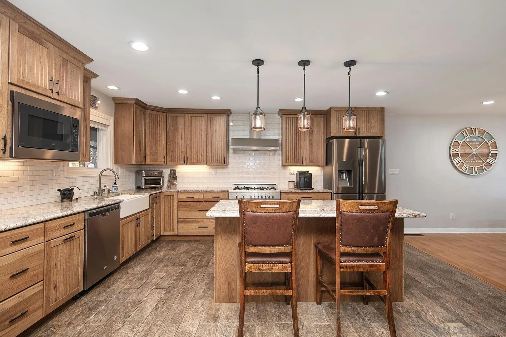 28710 Lone Pine Trail Pine Valley, CA 91962 - Photo 3 of 46 a large kitchen with cabinets chairs a sink and stainless steel appliances