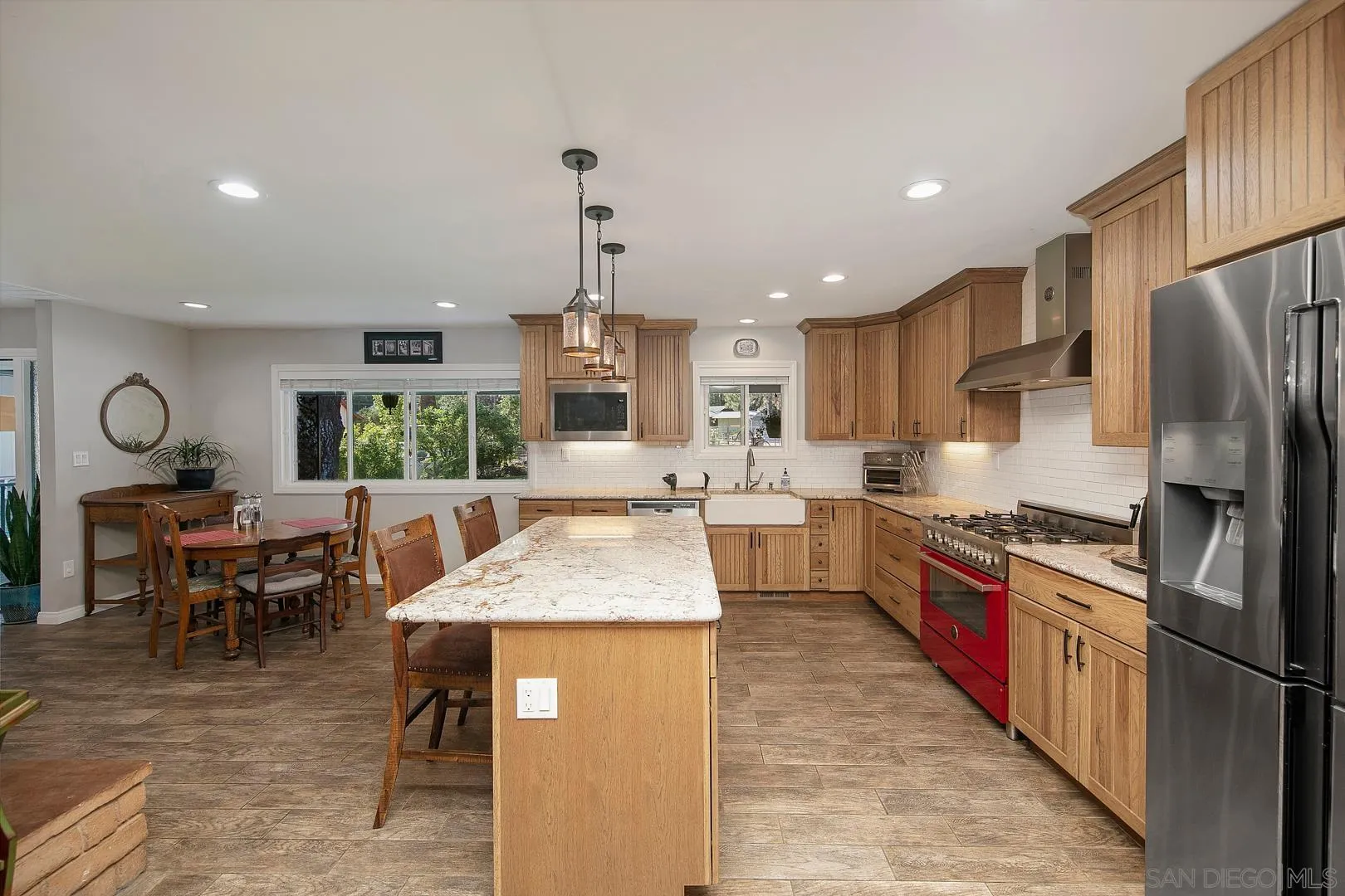 28710 Lone Pine Trail Pine Valley, CA 91962 - Photo 4 of 46 a kitchen with stainless steel appliances kitchen island granite countertop dining table chairs sink and cabinets