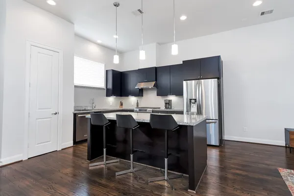 a large kitchen with a table and chairs