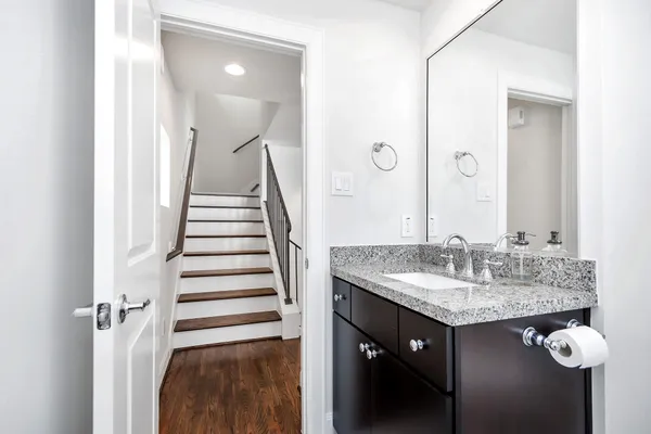 a bathroom with a granite countertop sink and a mirror