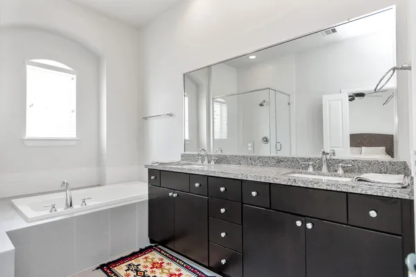 a bathroom with a double vanity sink mirror and double