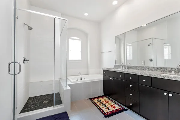 a bathroom with a sink a toilet a mirror and shower