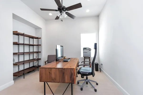 a view of a workspace with furniture