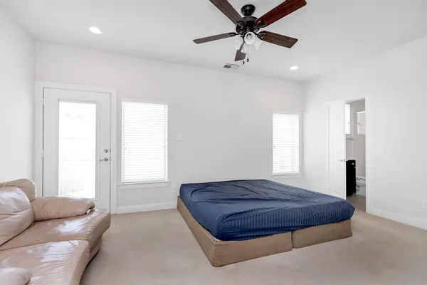 a large bedroom with a bed and furniture