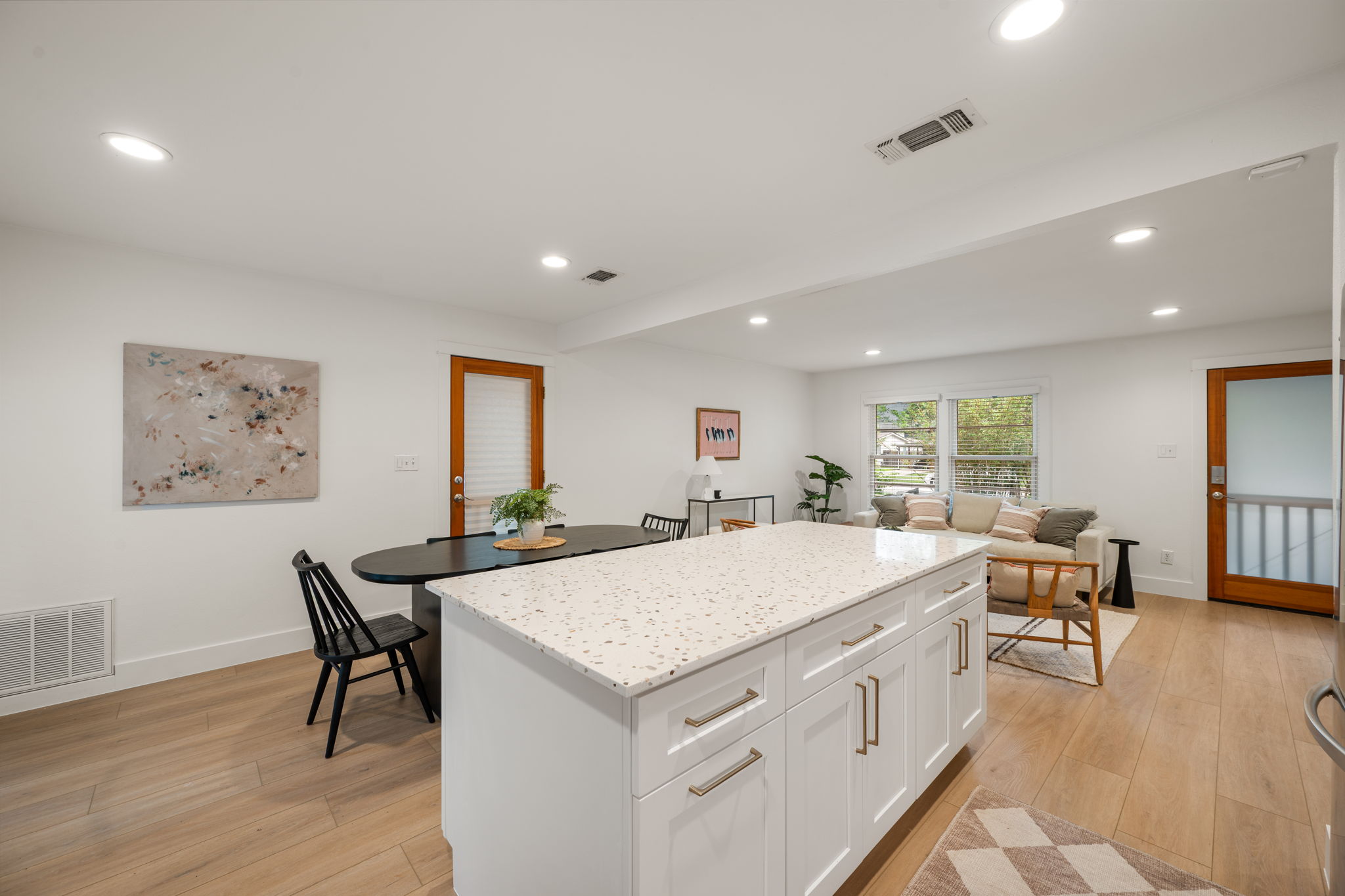5506 Duval Street Austin, TX 78751 - Photo 14 of 38 a living room with stainless steel appliances kitchen island granite countertop furniture and wooden floor