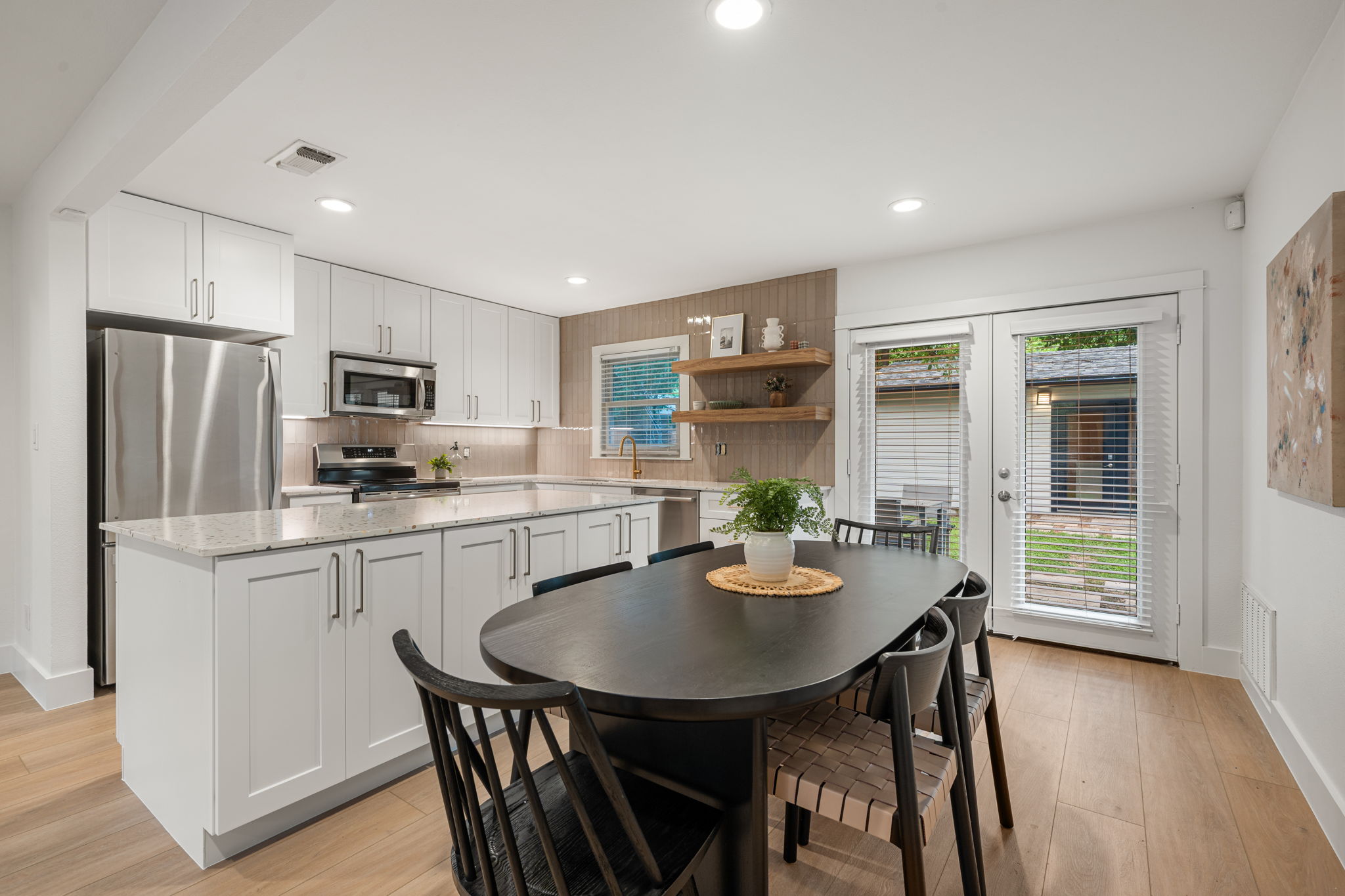 5506 Duval Street Austin, TX 78751 - Photo 15 of 38 a kitchen with refrigerator a sink dining table and chairs