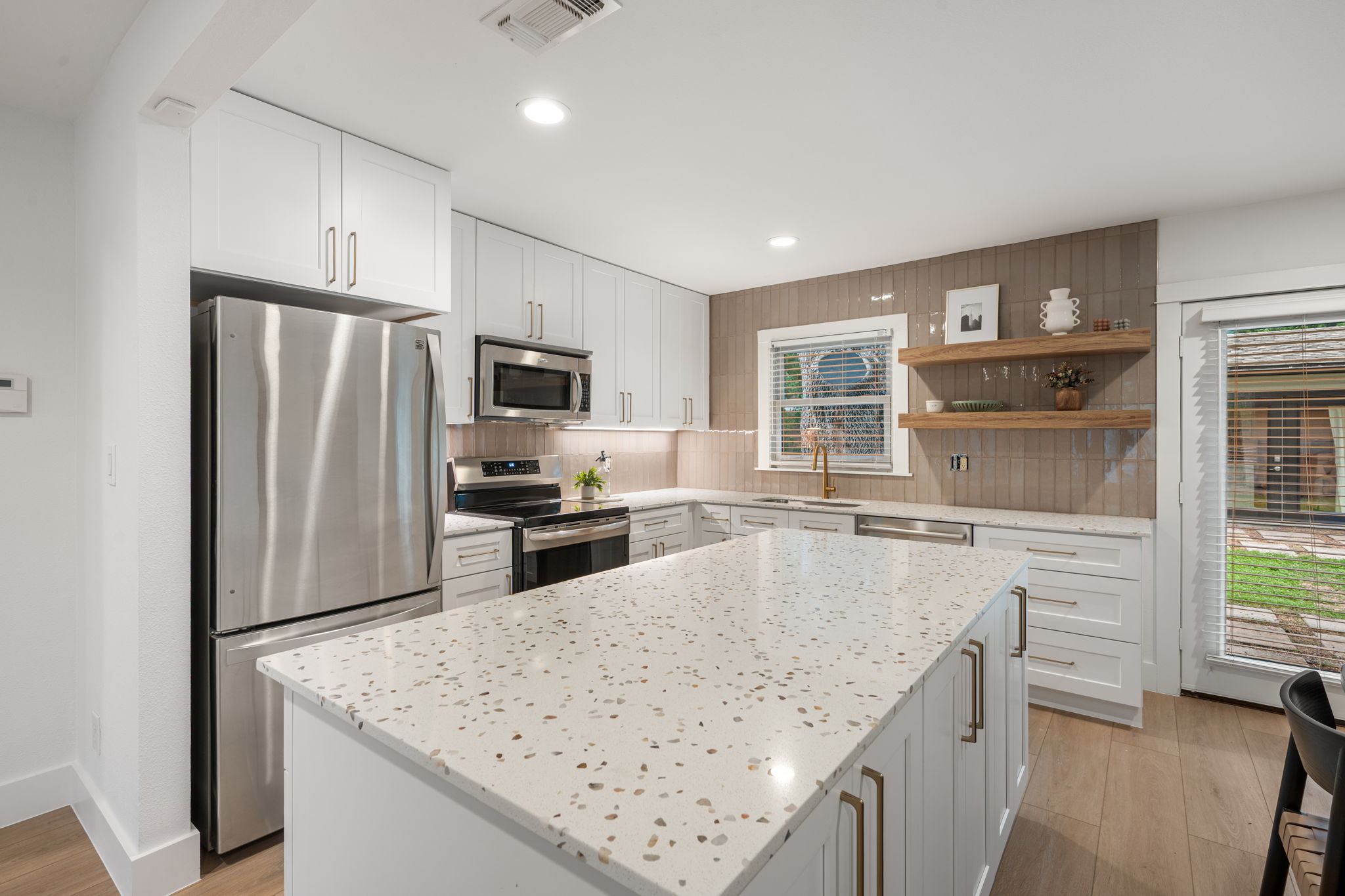 5506 Duval Street Austin, TX 78751 - Photo 2 of 38 a kitchen with stainless steel appliances granite countertop a refrigerator a stove and a sink