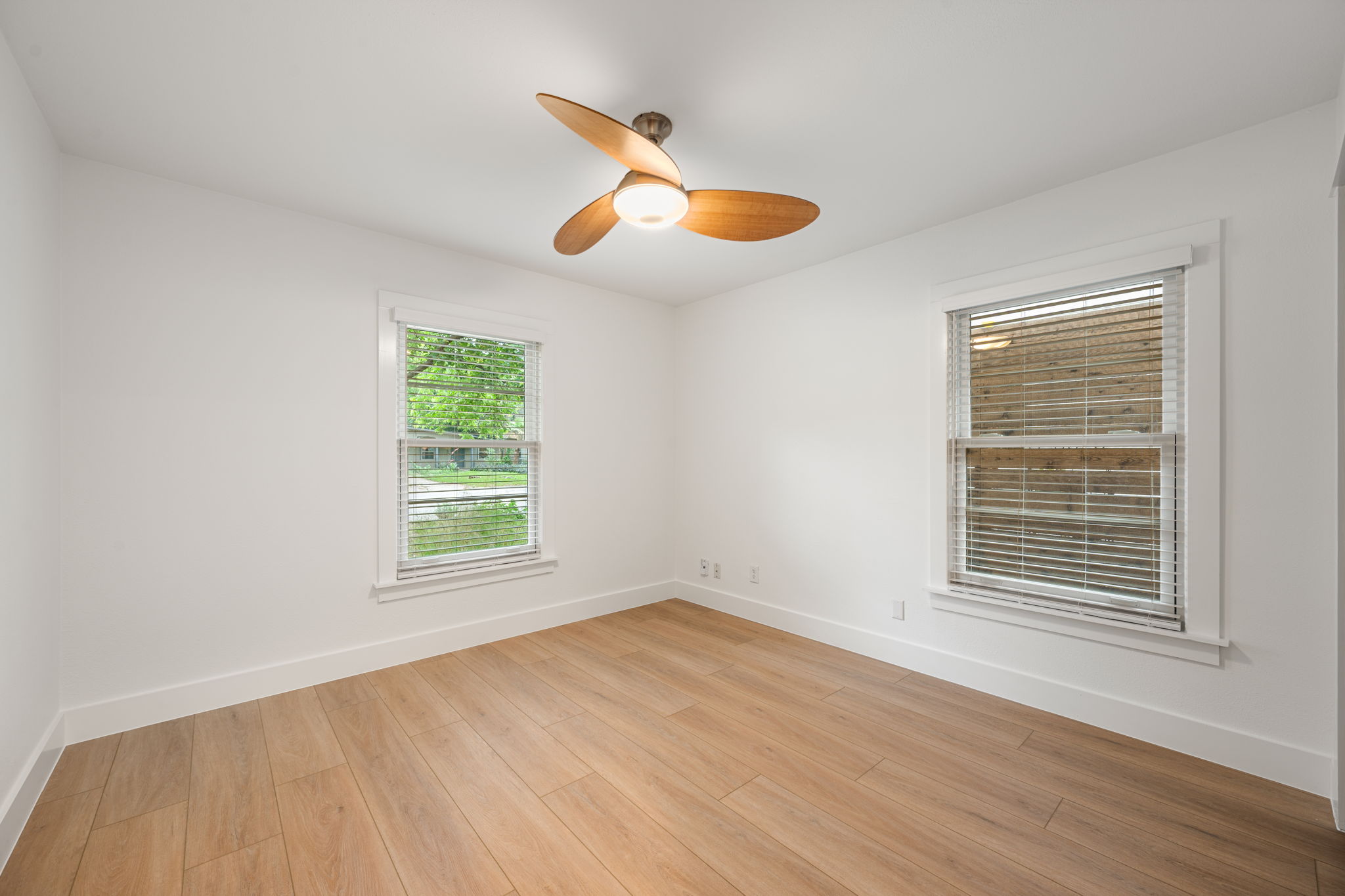 5506 Duval Street Austin, TX 78751 - Photo 23 of 38 a view of an empty room with wooden floor and a window