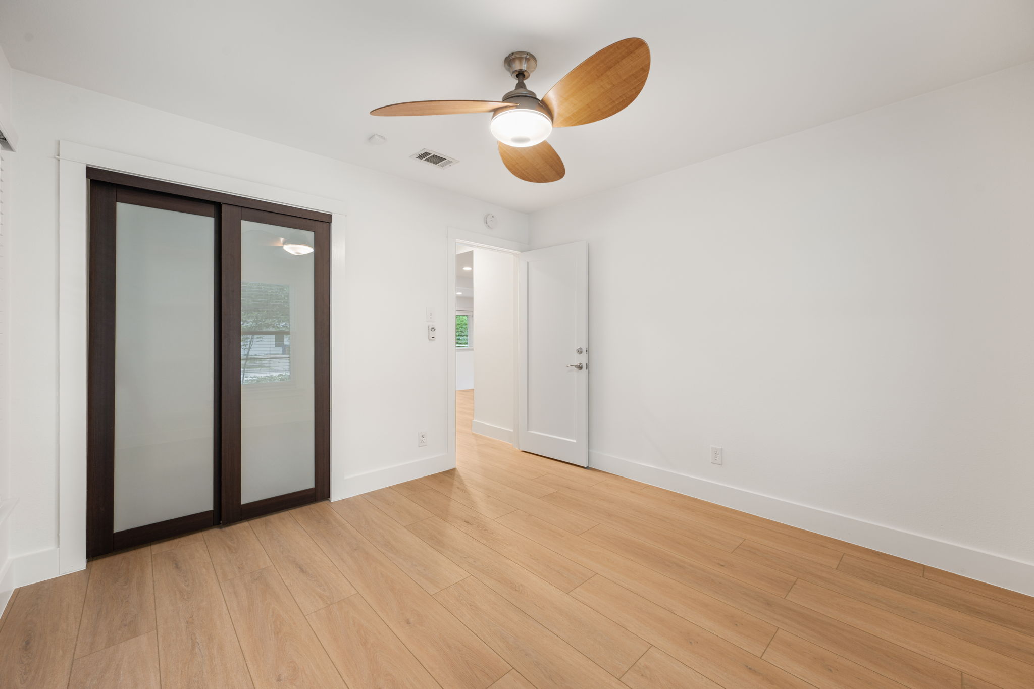 5506 Duval Street Austin, TX 78751 - Photo 24 of 38 wooden floor in an empty room with a window