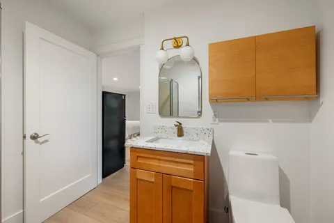 a bedroom with furniture and wooden floor