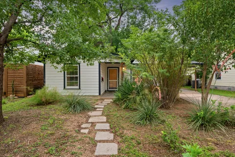 a backyard of a house with garden and trees