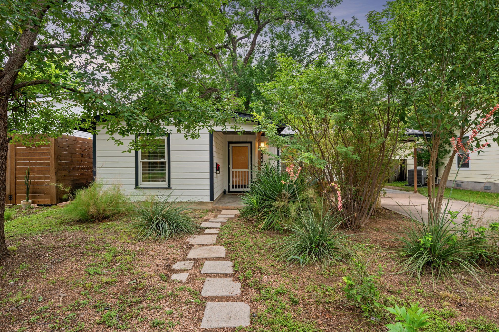 5506 Duval Street Austin, TX 78751 - Photo 5 of 38 a backyard of a house with garden and trees
