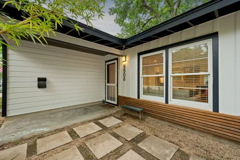 a view of a house with a small backyard
