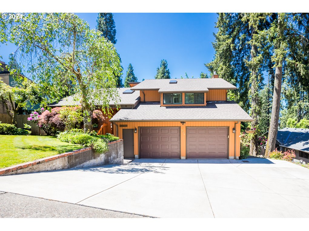 594 South 72nd Street Springfield, OR 97478 - Photo 1 of 14 a front view of a house with a garden