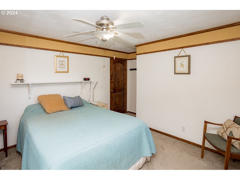 594 South 72nd Street Springfield, OR 97478 - Photo 13 of 14 a bedroom with a bed and a chandelier