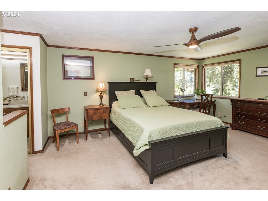 594 South 72nd Street Springfield, OR 97478 - Photo 14 of 14 a large bedroom with a bed and wooden floor