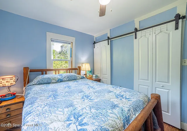 a bedroom with a bed dresser and a window