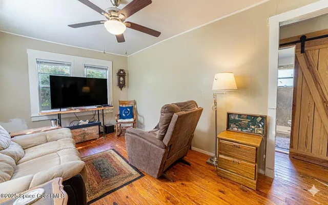 a living room with furniture and a flat screen tv