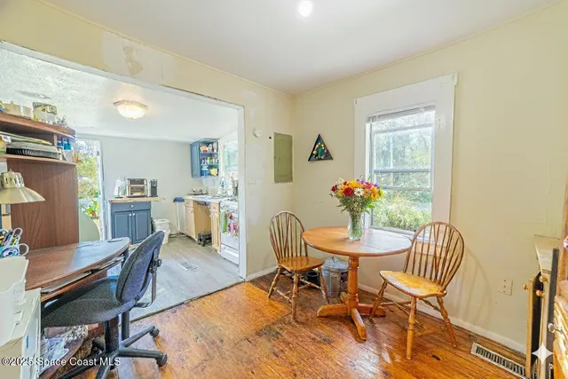 a dining room with furniture and window