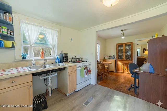 a kitchen with a sink stove and cabinets