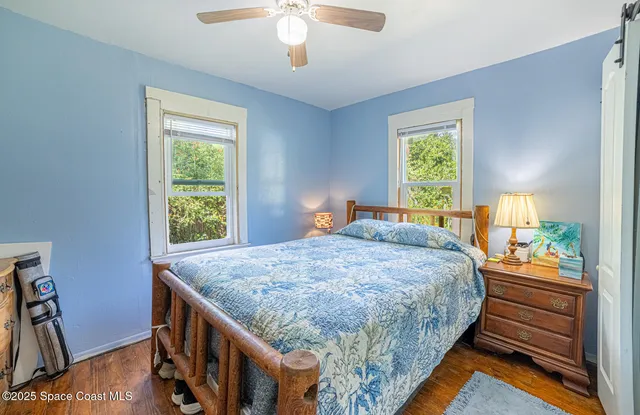 a bed sitting in a bedroom next to a window
